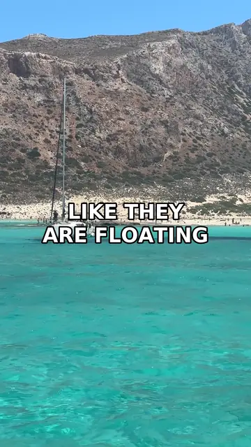 One frame of a real LoopBatch video: a boat on clear turquoise water off a Greek island, with the burned-in caption LIKE THEY ARE FLOATING